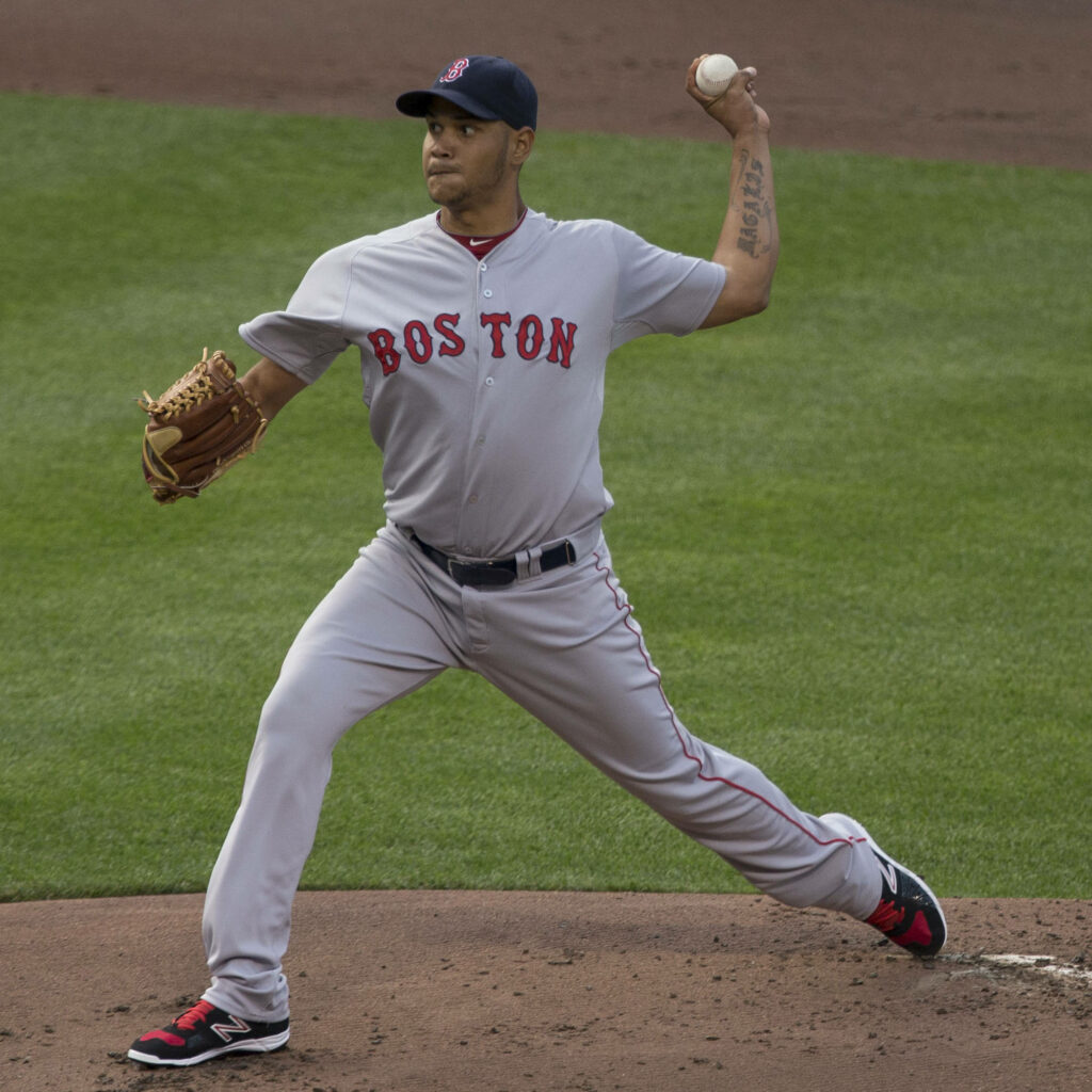 Eduardo Rodríguez pitching in Boston Red Sox uniform on green field with stadium backdrop wallpaper