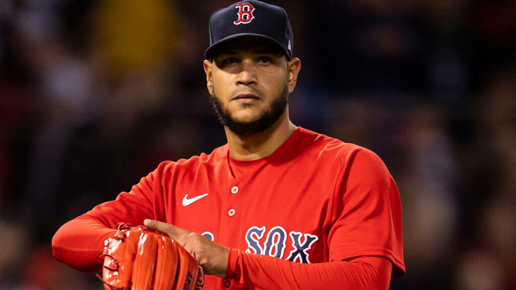 Eduardo Rodríguez pitching in Boston Red Sox red uniform under stadium lights focused intensity Wallpaper