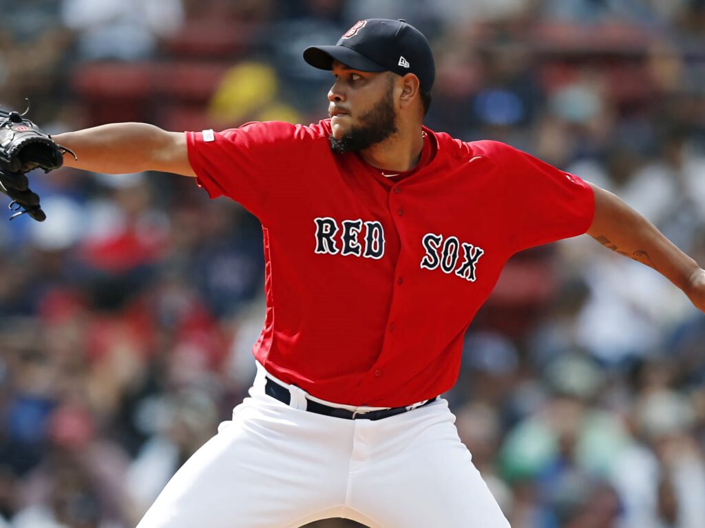 Eduardo Rodríguez pitching in red Boston Red Sox jersey with intense focus on mound wallpaper