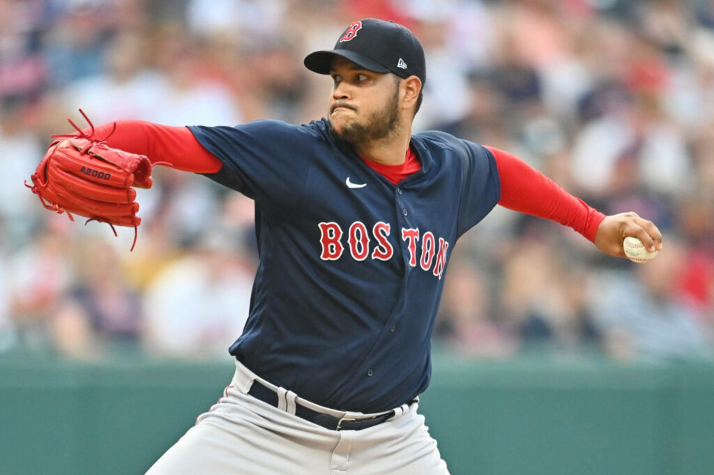 Eduardo Rodríguez pitching for Boston Red Sox in navy red white uniform with crowd background Wallpaper