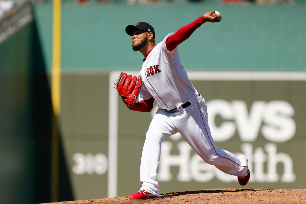 Eduardo Rodríguez pitching in Boston Red Sox uniform with red glove at classic stadium Wallpaper