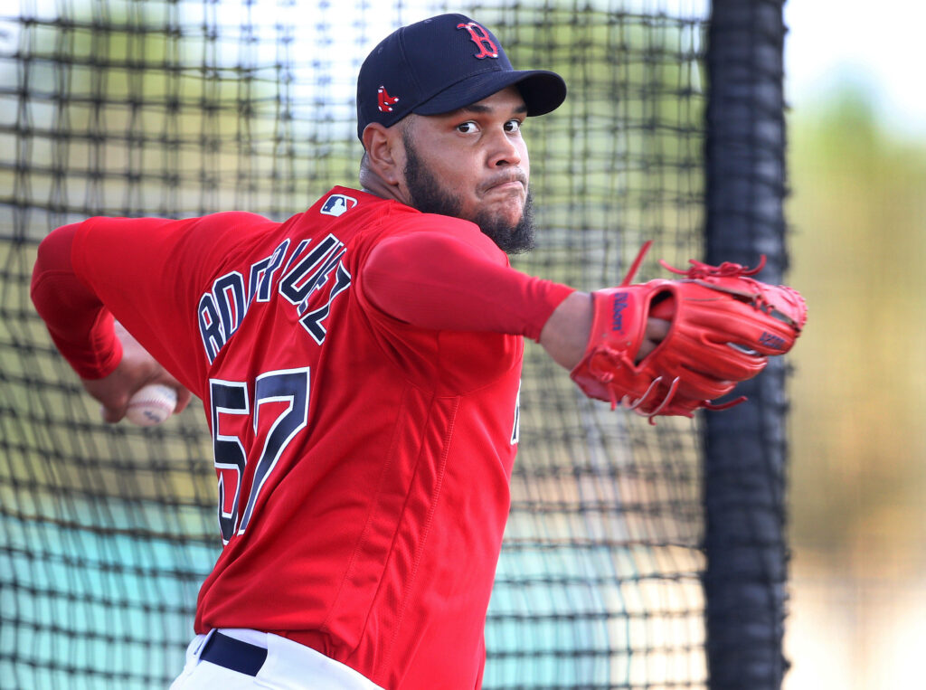Eduardo Rodríguez Boston Red Sox number 57 pitching mid-practice in vibrant team colors Wallpaper