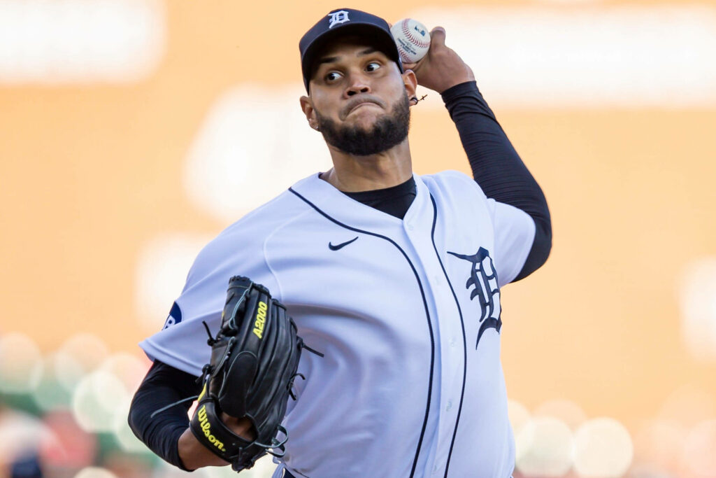 Eduardo Rodríguez pitching for Detroit Tigers in white navy uniform with focused expression Wallpaper