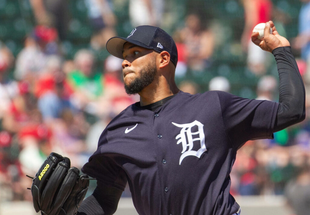 Eduardo Rodríguez pitching for Detroit Tigers in navy uniform focused athletic form stadium background Wallpaper