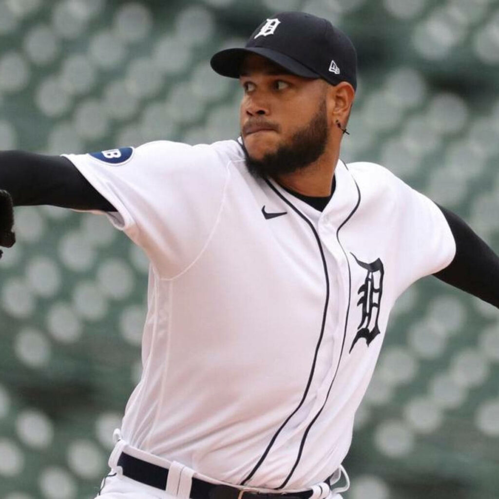 Eduardo Rodríguez pitching in Detroit Tigers white uniform with blurred stadium background Wallpaper
