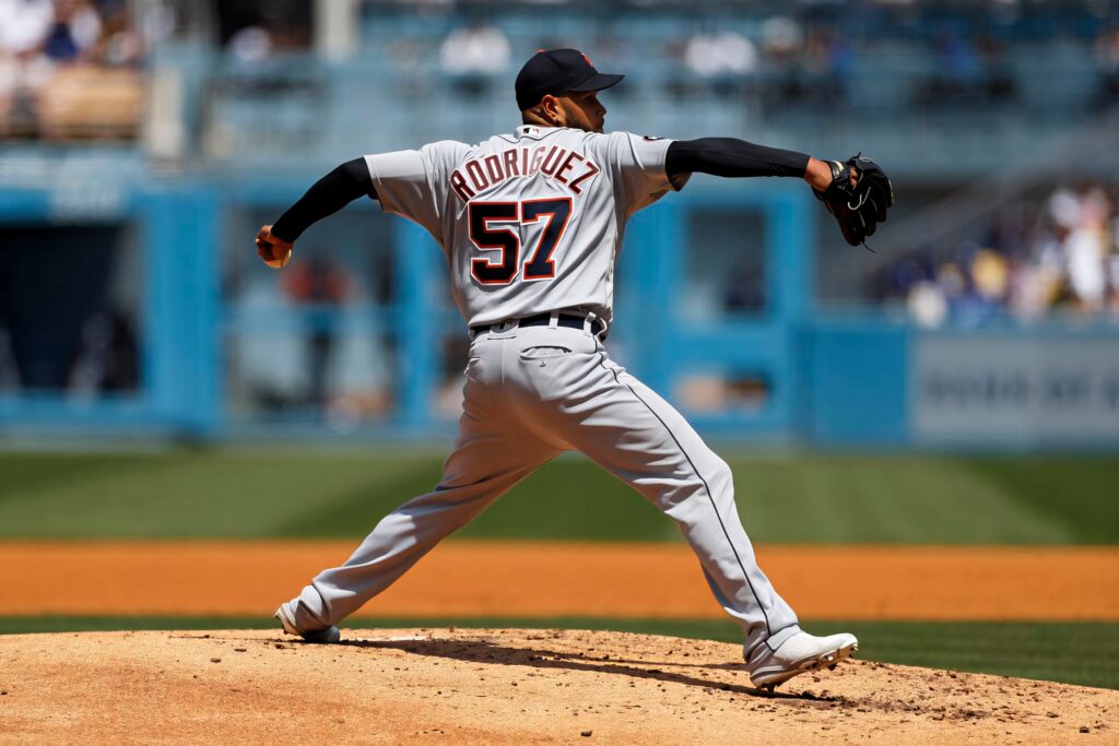 Eduardo Rodríguez pitching in gray navy uniform number 57 on vibrant baseball field wallpaper