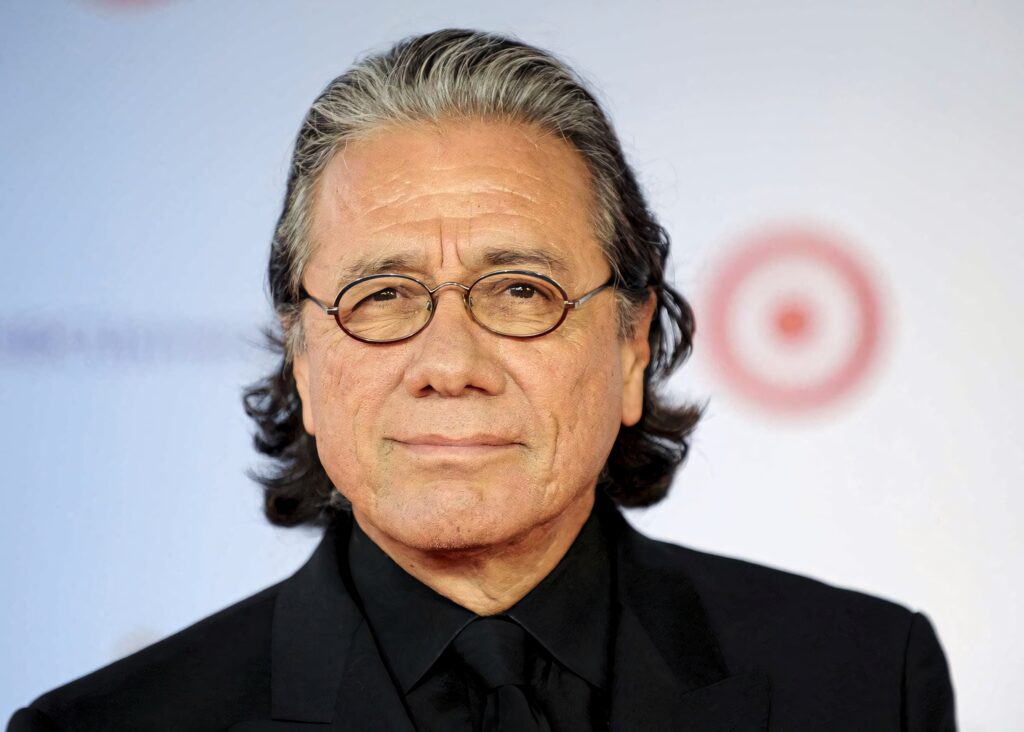 Edward James Olmos close-up portrait with confident expression wearing classic dark suit and glasses Wallpaper