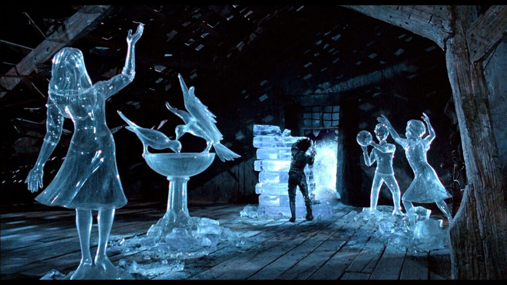 Edward Scissorhands crafting delicate ice sculptures of women and birds in blue lit attic background Wallpaper