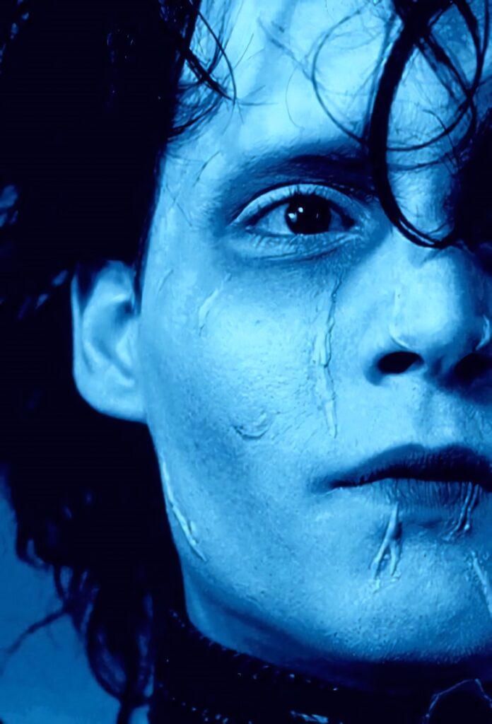 Close up of Edward Scissorhands with pale skin scars intense expression haunting gentle look wallpaper