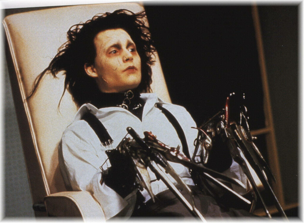 Edward Scissorhands sitting on chair with iconic scissor hands and gothic style wallpaper