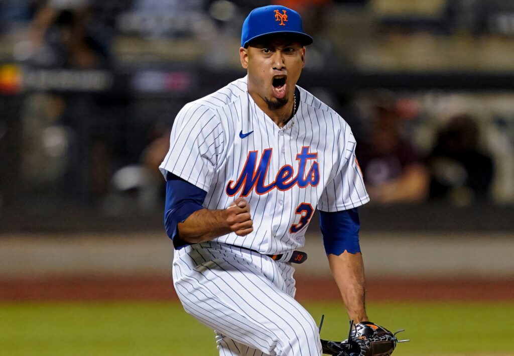 Edwin Diaz celebrates intense baseball moment in sharp focus wearing Mets blue orange uniform wallpaper background