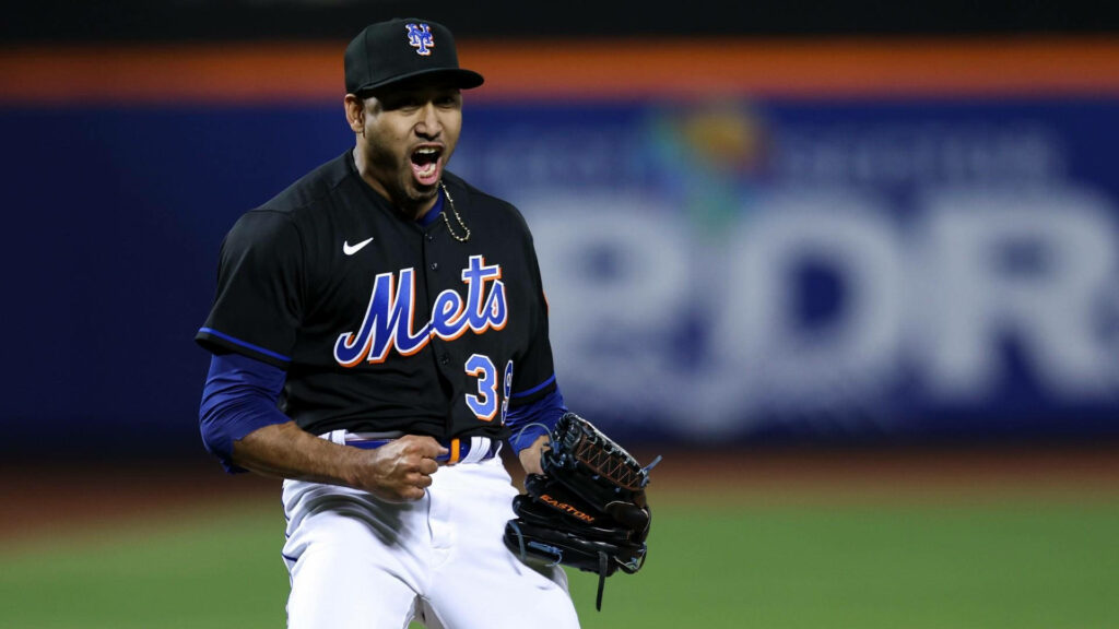 Edwin Diaz pitching intensely in black New York Mets jersey vibrant blue orange accents background Wallpaper