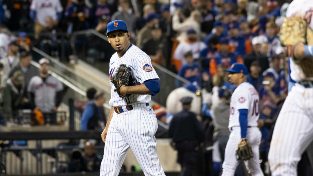 Edwin Diaz pitching for New York Mets in pinstripe uniform with vibrant stadium crowd background Wallpaper