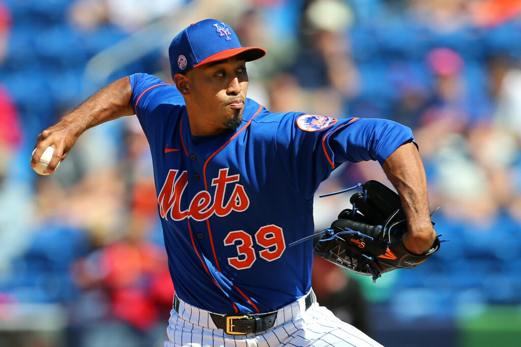 Edwin Diaz pitching in blue New York Mets jersey focused on vibrant baseball field action Wallpaper