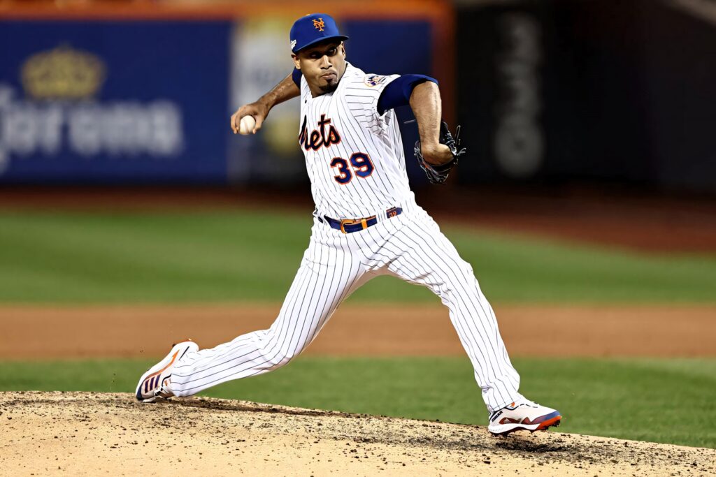 Edwin Diaz New York Mets pitcher mid-pitch in home pinstripe jersey under stadium lights Wallpaper