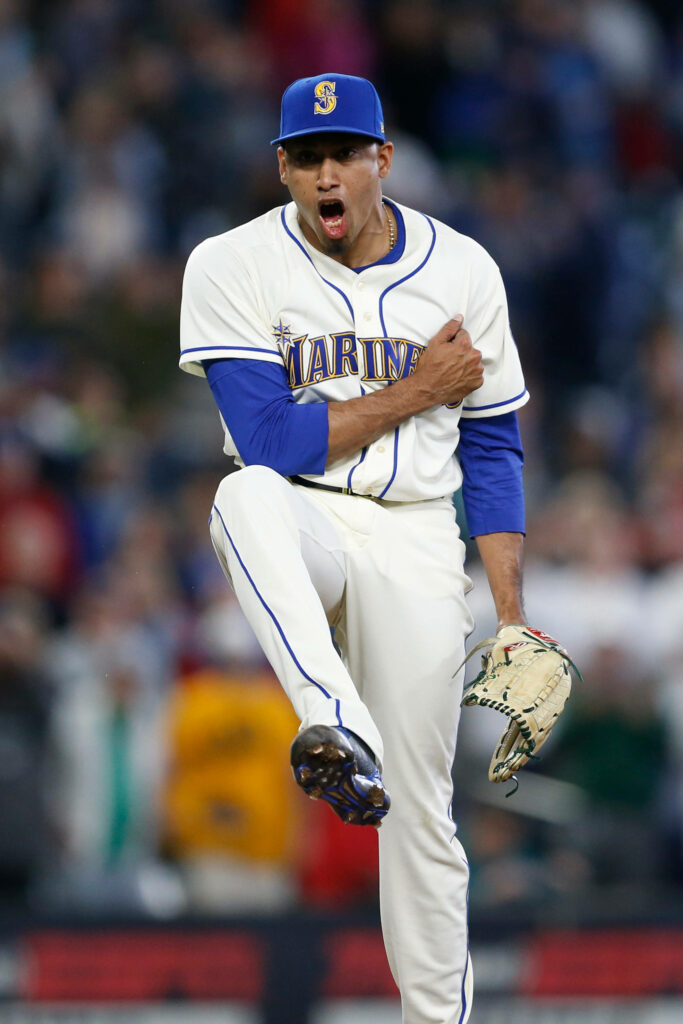 Edwin Diaz pitching in Seattle Mariners uniform showing energy and focus on baseball field Wallpaper