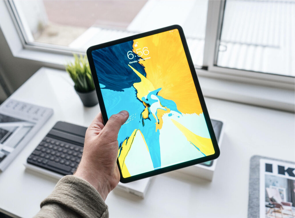 Sophisticated iPad Set-up: Stylishly Equipped Home Office Featuring the Apple iPad Pro with Smart Keyboard Wallpaper