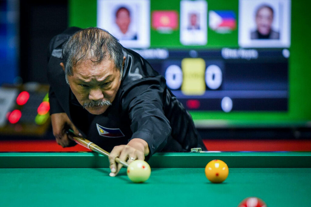 Efren Bata Reyes focused lining up a precise shot showcasing legendary billiards skill wallpaper