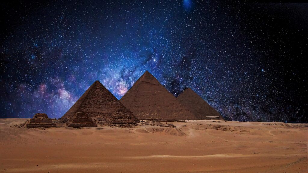Egypt pyramids under Milky Way night sky vibrant blue cosmic ancient architecture wallpaper