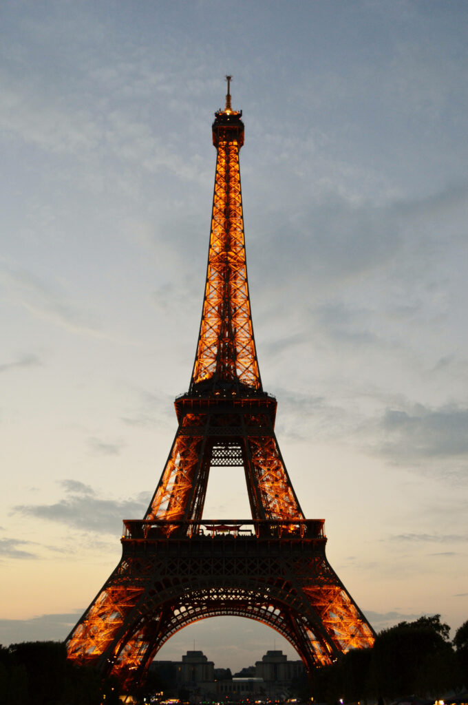 Illuminated Eiffel Tower at dusk glowing golden romantic Paris wallpaper background for phone
