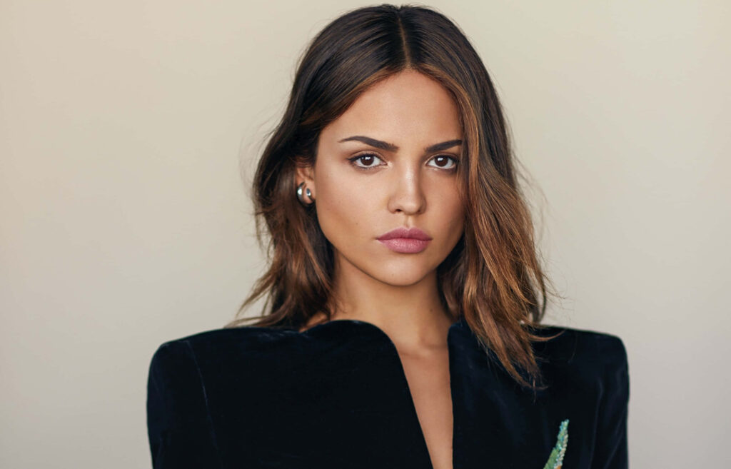 Eiza González portrait with loose waves natural makeup black outfit elegant modern high-resolution photo Wallpaper