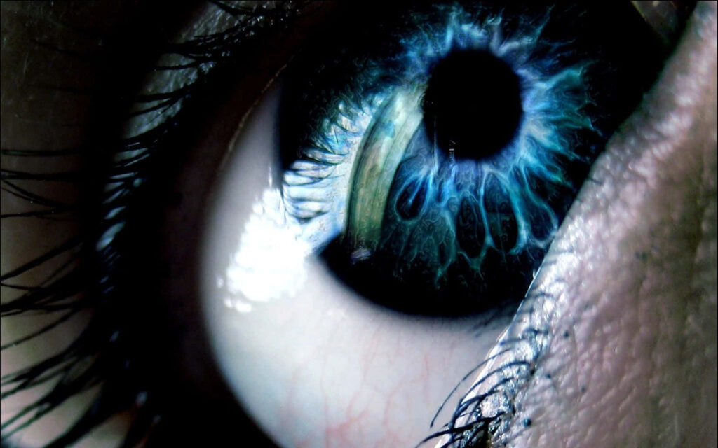 Closeup of a vibrant blue eye with detailed iris and glowing electric light rays wallpaper background