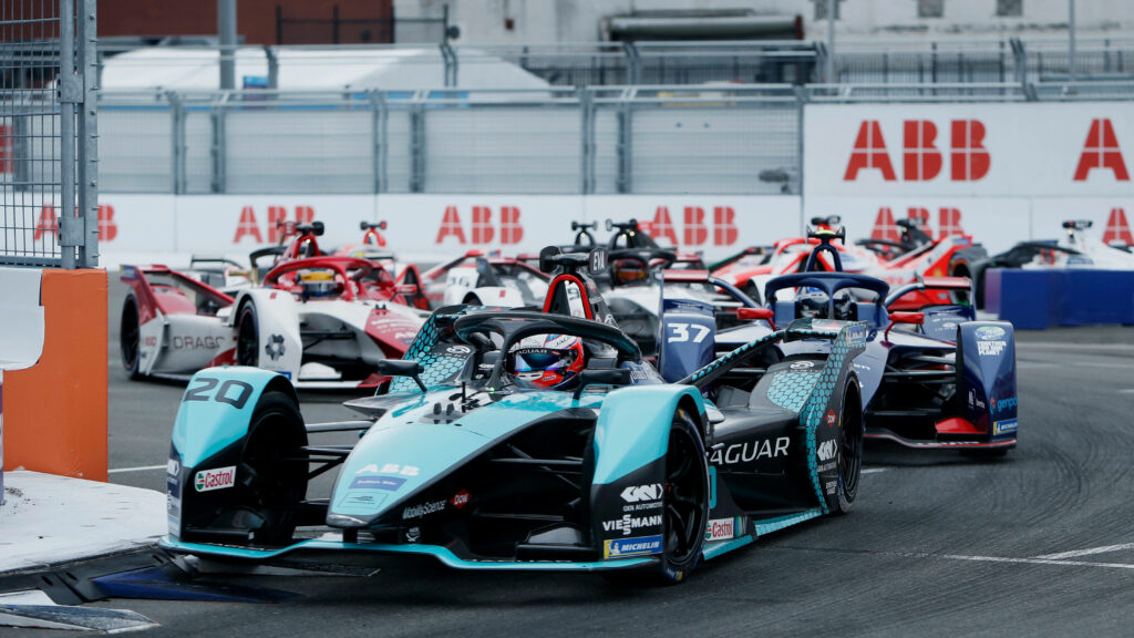 Electric Formula E race cars speeding on New York City street circuit during ABB FIA championship Wallpaper