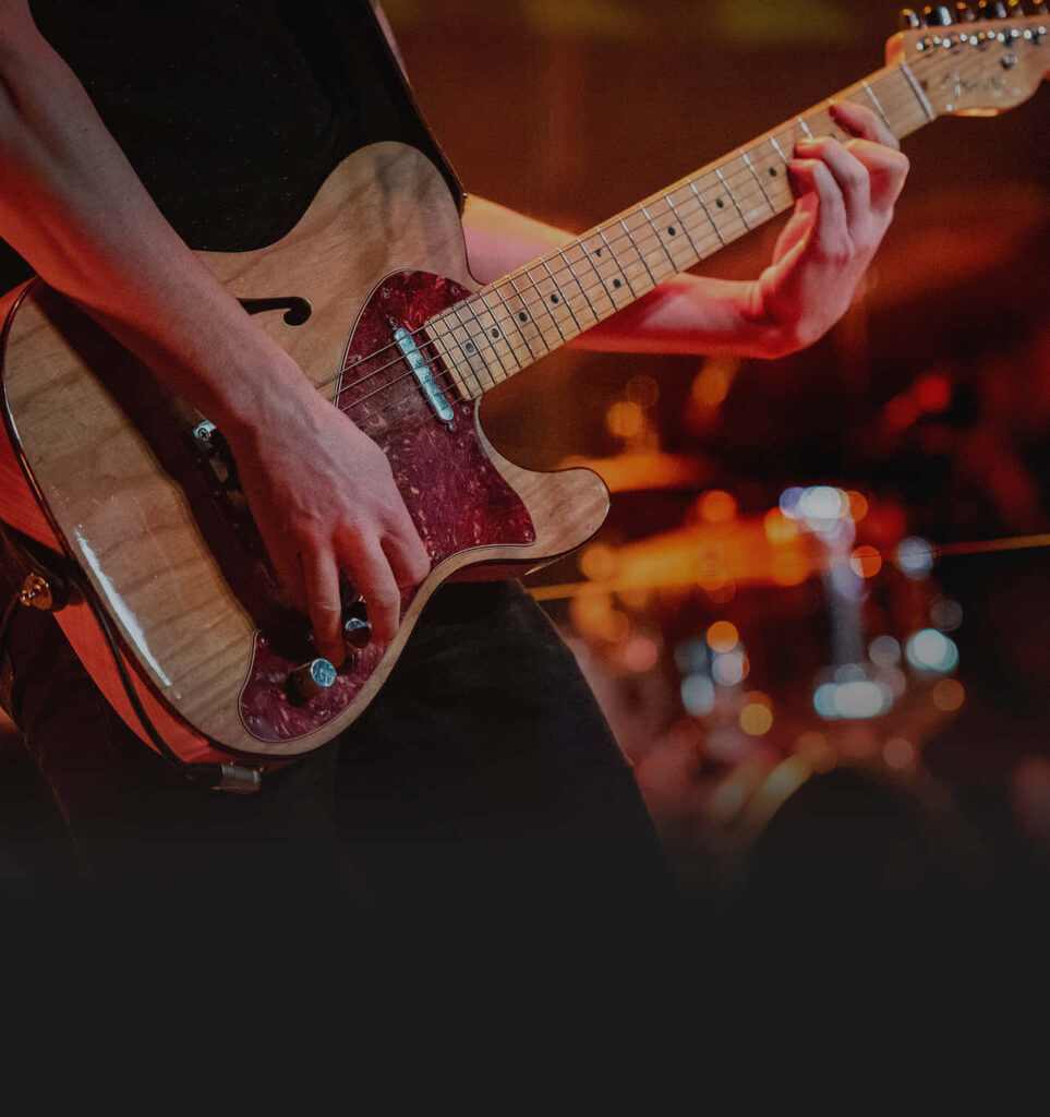 Dynamic Musician Wallpaper: Electric Guitar Live Performance Background