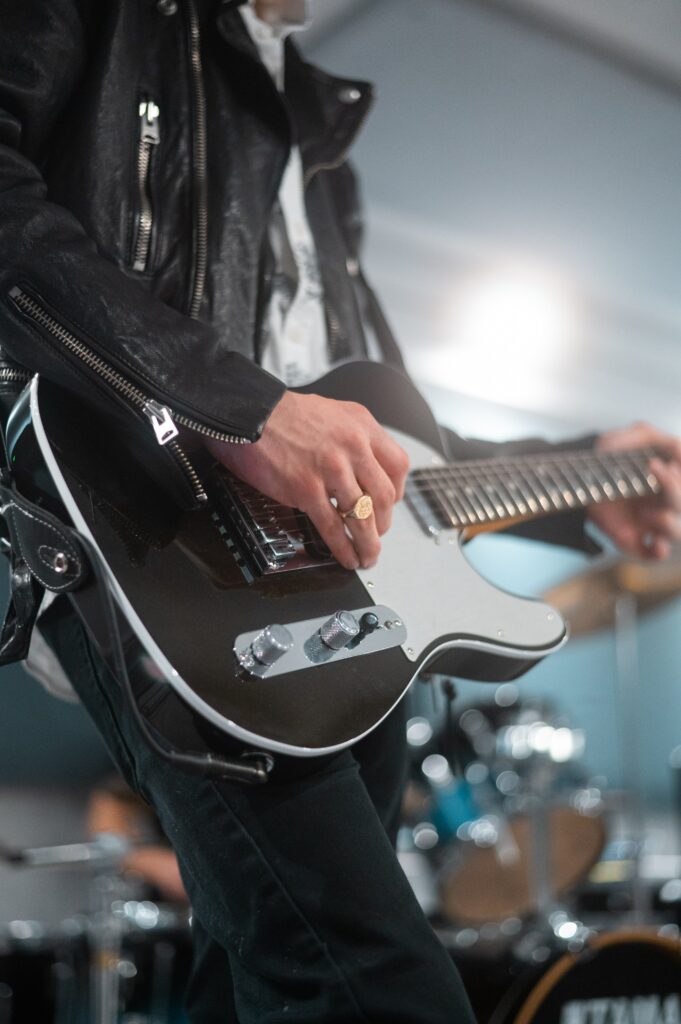 Dynamic Guitarist Wallpaper: Electric Music Energy in Concert