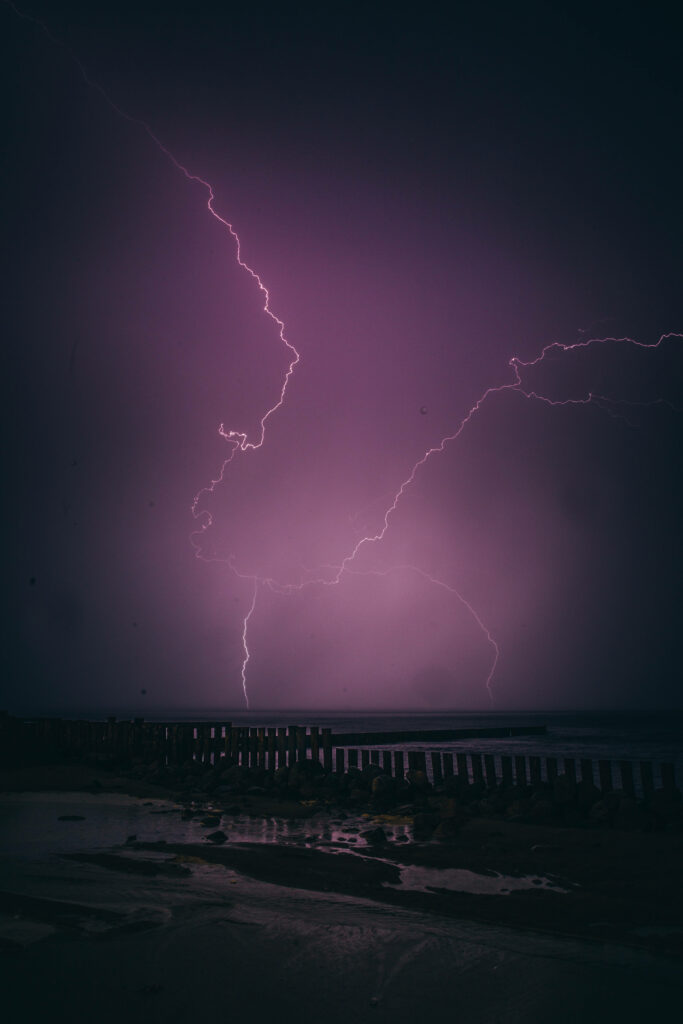 Vibrant Violet Visions: Illuminate Your iPhone with a Captivating Lightning Display Wallpaper
