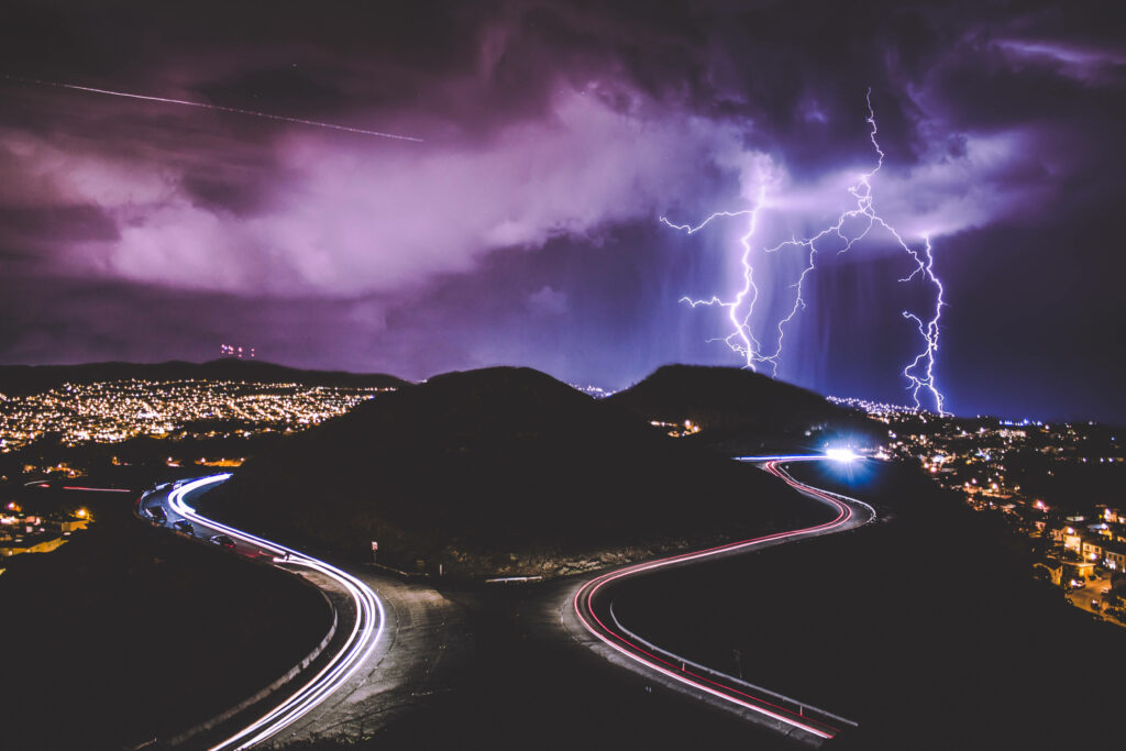 Electrifying Skylines: A Dazzling Display of City Lights under a Torrent of Lightning Wallpaper