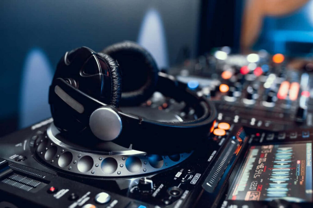 Electrifying DJ Setup Wallpaper: High-Quality Headphones & Mixers