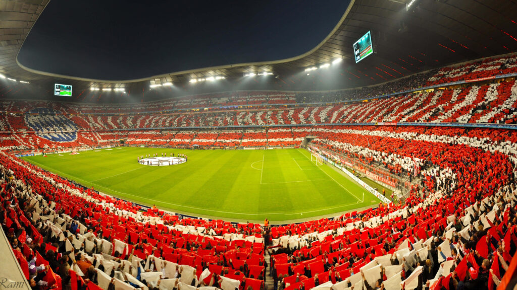 Electric Football Atmosphere: Vibrant Stadium Wallpaper Background