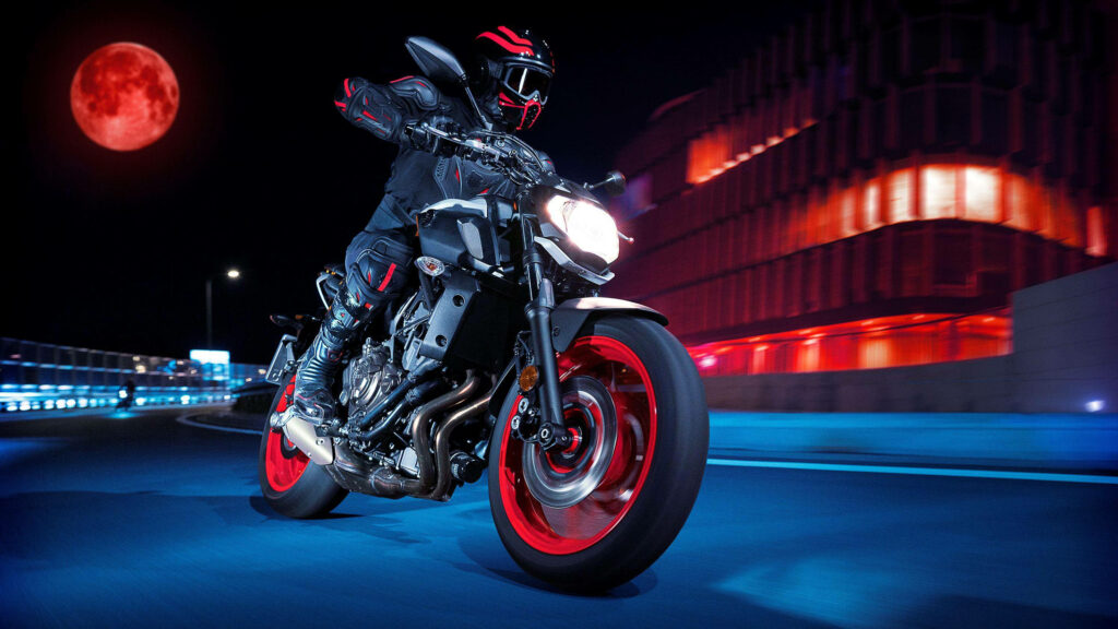 Electric Wallpaper: Rider on Yamaha MT-15 Under Red Moon Glow