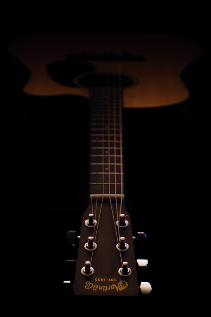 Elegant Acoustic Guitar Wallpaper on Dark Dramatic Background