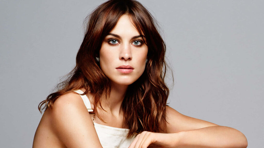 Elegant Alexa Chung portrait wallpaper showcasing chic style and poised expression on background