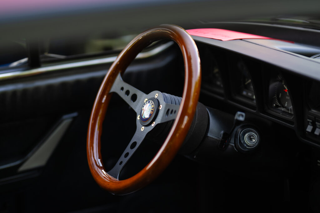 Elegant Alfa Romeo Interior Wallpaper: Classic Wooden Steering Wheel