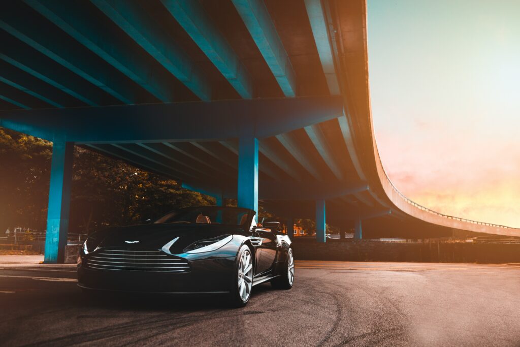 Sleek Aston Martin Under Bridge - Elegant High-Res Wallpaper