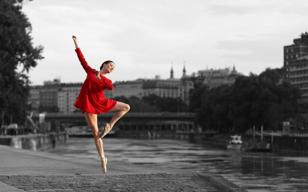 Elegance in Motion: A Captivating Ballerina Dancing in a Promenade Wallpaper