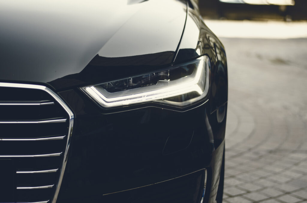 Sleek Black Car Front View Wallpaper with Modern Headlights