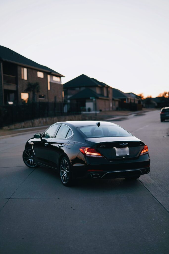 Sleek Black Car Rear View: Modern Design in Suburban Setting Wallpaper