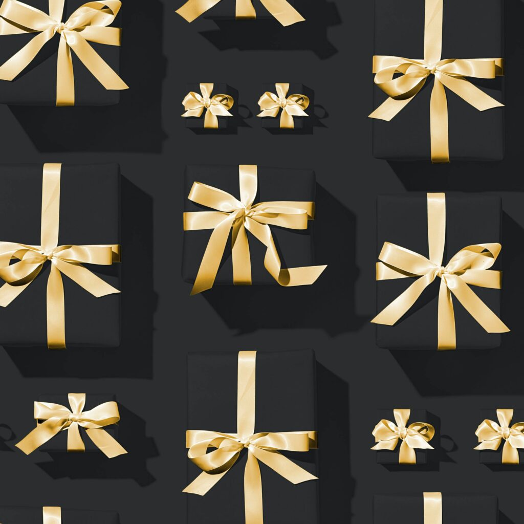 Elegant Black Gift Boxes with Gold Ribbons - Festive Wallpaper