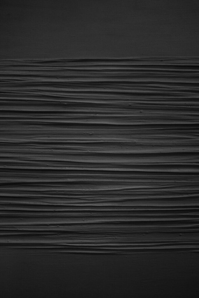 Sophisticated Black Textured Wallpaper with Horizontal Grooves