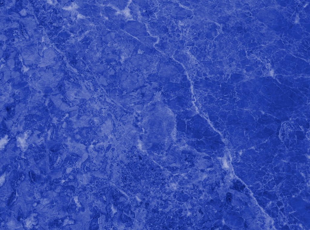 Blue marble wallpaper with rich vibrant stone texture and intricate white veins background