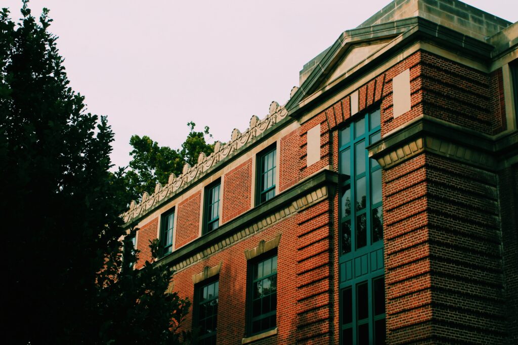 Elegant Brick Building Wallpaper with Trees & Classic Aesthetic