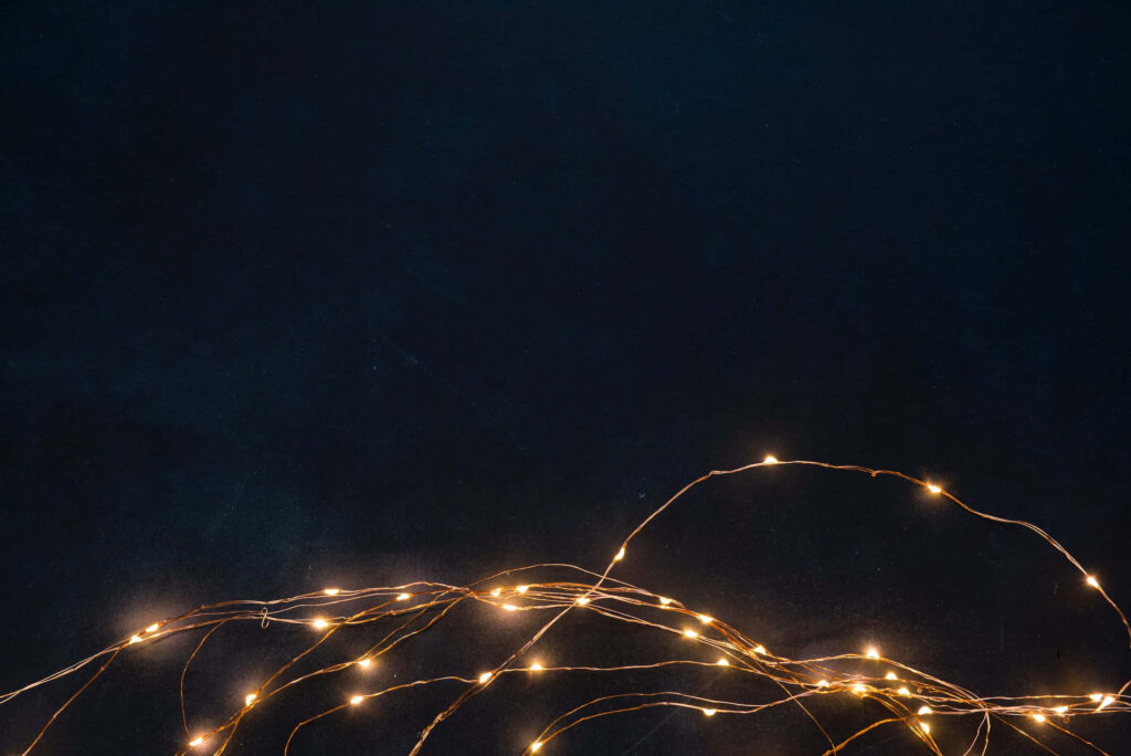 Elegant Dark Background with Warm Glowing Lights for Festive Decor Wallpaper