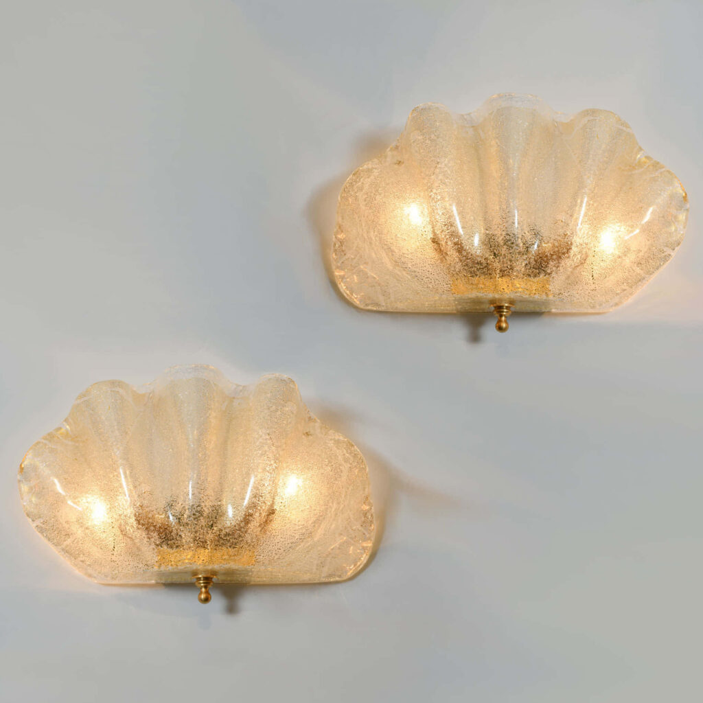 Elegant clam shell wallpaper with soft translucent tones and subtle golden coastal glow background
