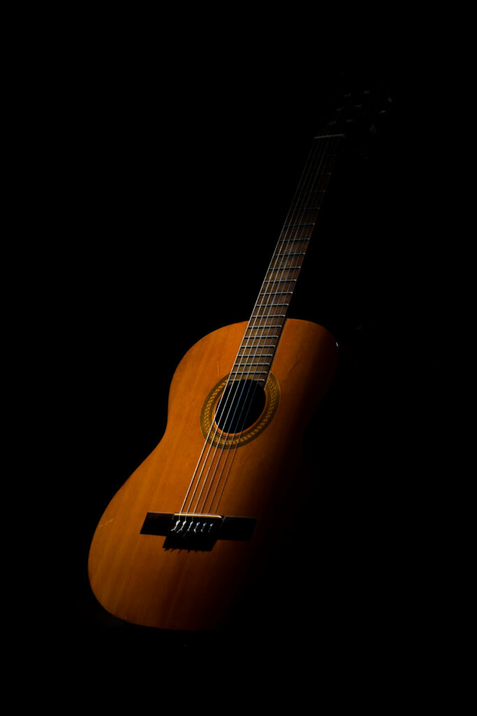 Elegant Classical Guitar Wallpaper on Dark Background