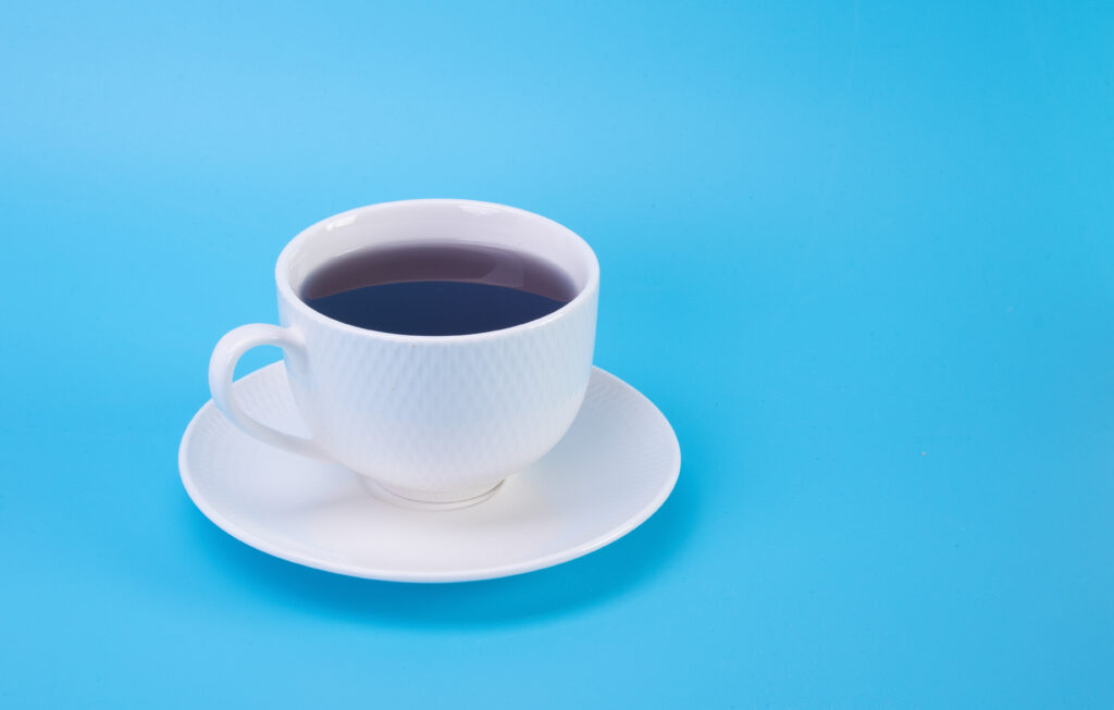 Elegant Coffee Cup Wallpaper on Bright Blue Background