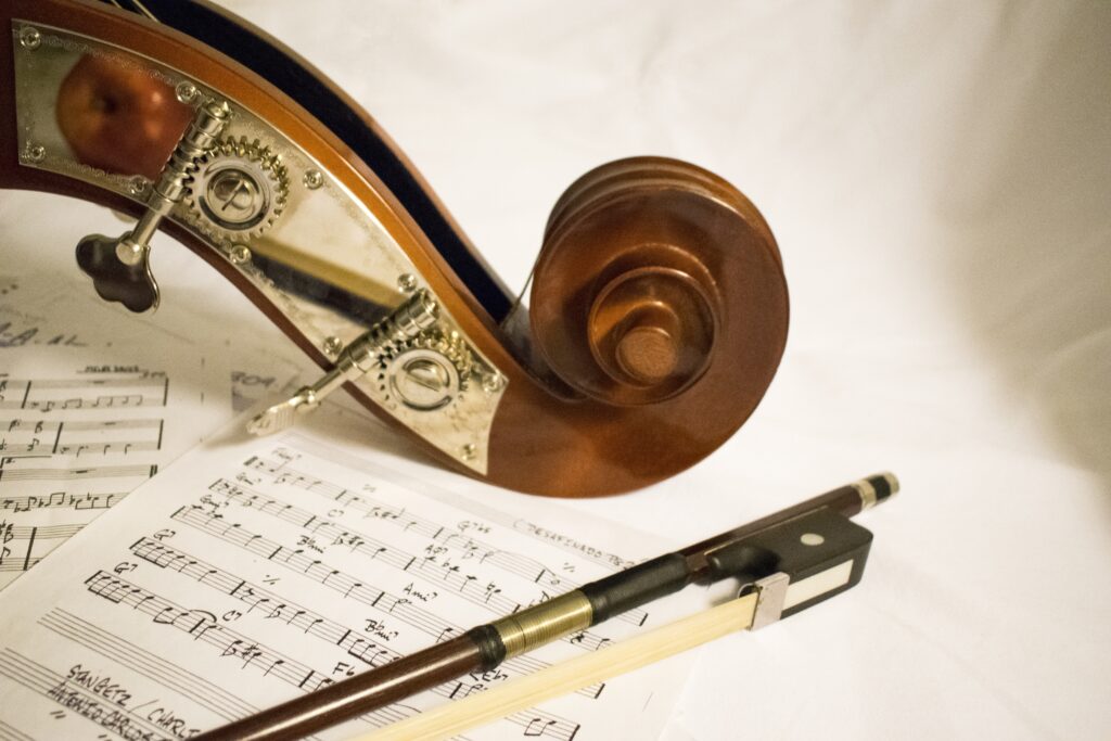 Elegant Contrabass Scroll Wallpaper with Sheet Music & Bow Background
